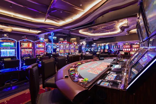 A glowing roulette wheel with cascading chips, symbolizing the engaging live and instant-win games available on 3777 BED.