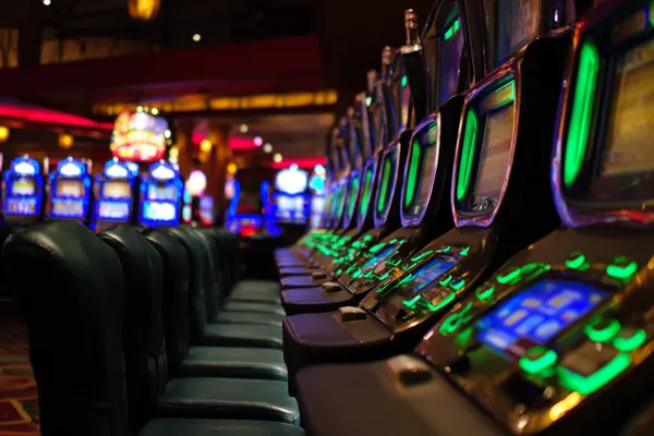 A woman in a luxurious green gown next to an ornate roulette wheel, capturing the upscale casino mood of 3777 BED.